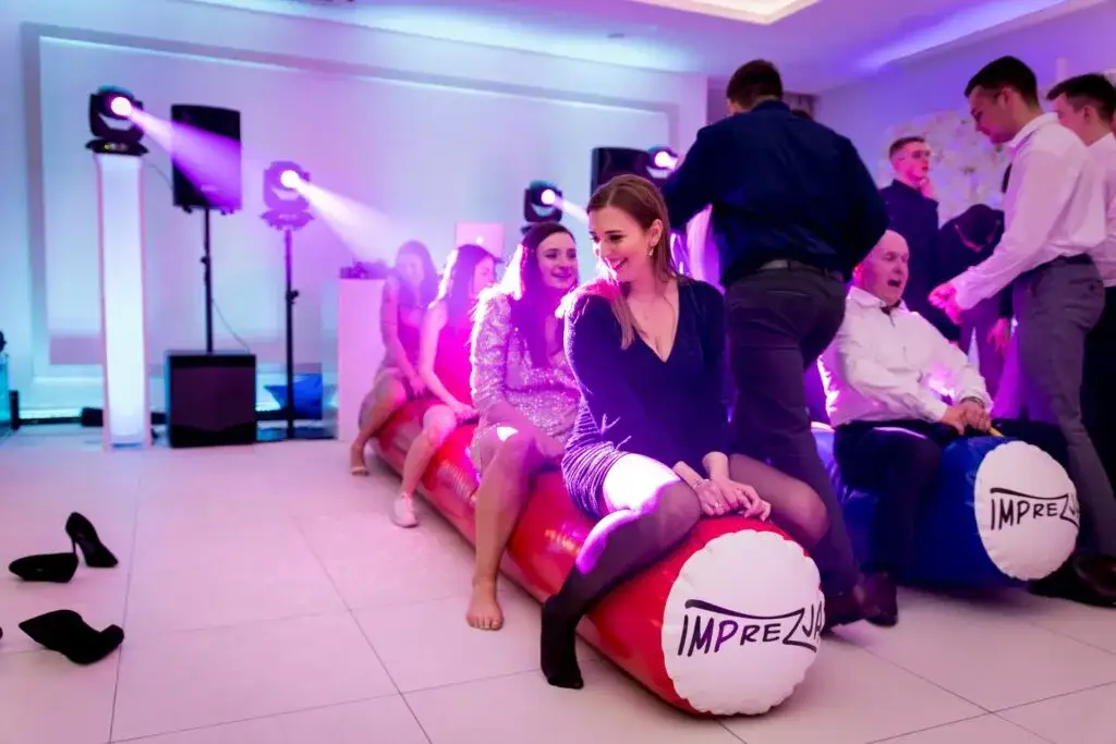 Młodzi ludzie tańczący na osiemnastce z DJ-em i oświetleniem